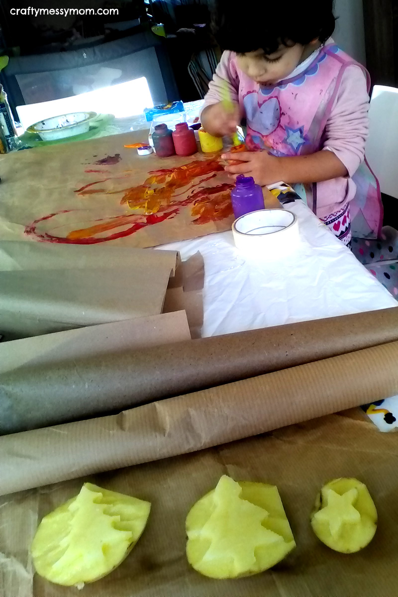 Christmas crafts - diy wrapping paper with potato stamps at craftymessymom.com